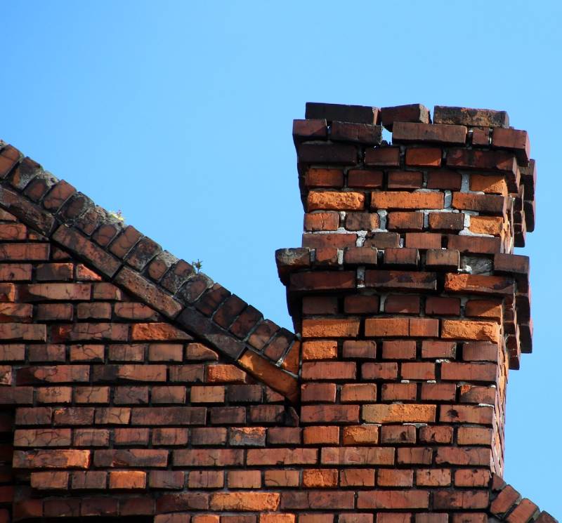 Blog Article - Damaged chimney on an Devens home showing cracks and missing mortar